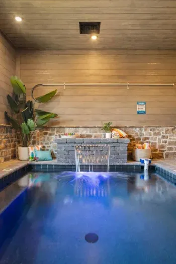 The indoor pool and waterfall features a color-changing LED lights, creating a magical, customizable glow - creating a playful and relaxing vibe.