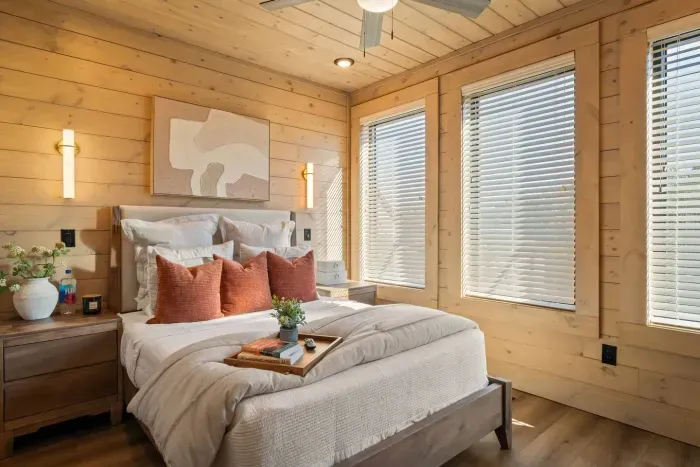 This cozy bedroom features a queen bed with a plush foam topper for added comfort, a TV for easy relaxation, and a stylish dresser to store clothes and personal items—blending comfort and convenience in a welcoming space.
