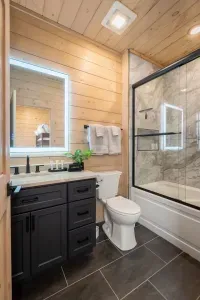 An upstairs bathroom is perfect for families, featuring a tub ideal for kids' bath time and a relaxing soak. It comes fully stocked with shampoo, conditioner, body wash, lotion, tampons, cotton pads, and Q-tips.