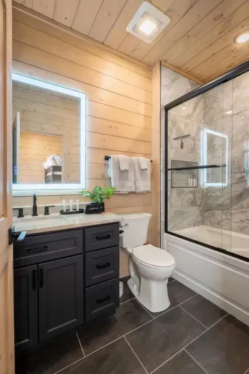 An upstairs bathroom is perfect for families, featuring a tub ideal for kids' bath time and a relaxing soak. It comes fully stocked with shampoo, conditioner, body wash, lotion, tampons, cotton pads, and Q-tips.
