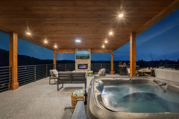 At night, the rooftop transforms into a cozy, open-air lounge. Sink into the outdoor couch or one of the cushioned chairs as the mounted TV sets the mood for a laid-back evening. Just steps away, the hot tub bubbles under the stars.

