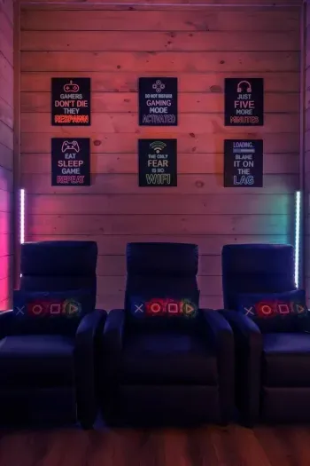 The game room has LED lights that shift colors and set a playful mood. Neon hues bounce off the walls, creating a fun, upbeat atmosphere that feels like your own private arcade. 
