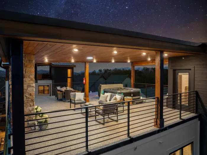 The rooftop glows, with cozy seating, a bubbling hot tub, and the soft hum of the mountains all around. Whether you're curled up on the couch, soaking in the hot tub, or watching a movie under the stars, the rooftop turns into a elevated escape.