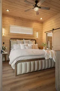 The master bedroom offers a true retreat with a luxurious king-size bed, plush bedding, and an inviting, serene atmosphere. Sliding glass doors provide direct access to the balcony, blending indoor comfort with peaceful outdoor views.