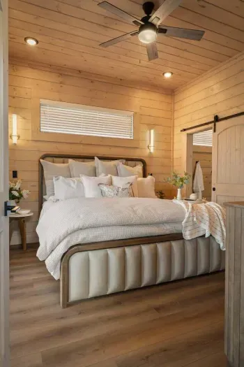 The master bedroom offers a true retreat with a luxurious king-size bed, plush bedding, and an inviting, serene atmosphere. Sliding glass doors provide direct access to the balcony, blending indoor comfort with peaceful outdoor views.
