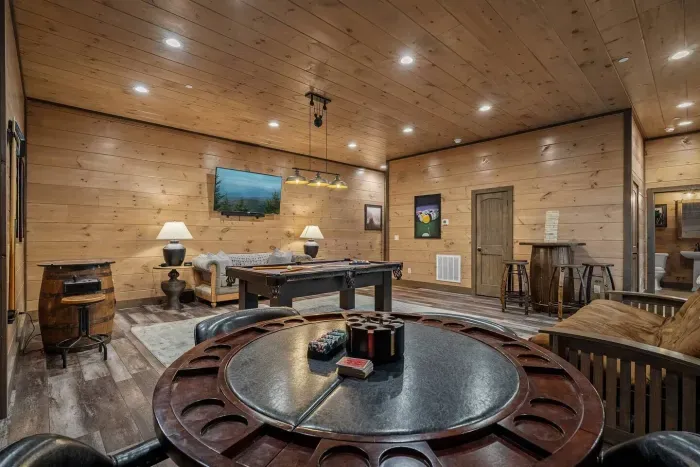 Gather around the poker table with built-in cupholders, perfect for late-night card games and friendly competition. From your seat, you’ll have a clear view of the pool table and large TV.
