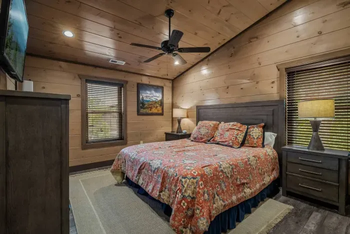 Tucked upstairs, the third bedroom offers comfort and charm with its pretty red bedding, space for your things, and a cozy atmosphere that feels like home. 