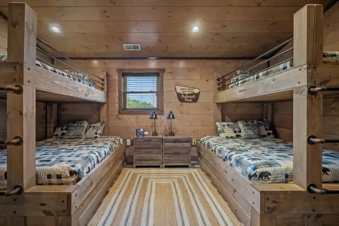 The second bunk room brings the Smokies indoors with blue plaid and bear comforters—the perfect mix of cozy and fun for kids or adults alike.