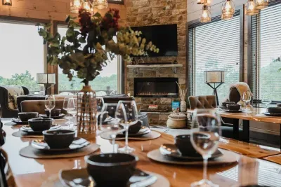 Detail shot of the dining table, with the view of the luxury living room + cozy stone fireplace.