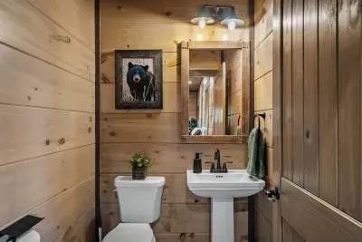 The downstairs half bath is perfectly placed — right outside the pool room and just steps from the game room. No need to trek upstairs between swims or game night battles… everything you need is right here!