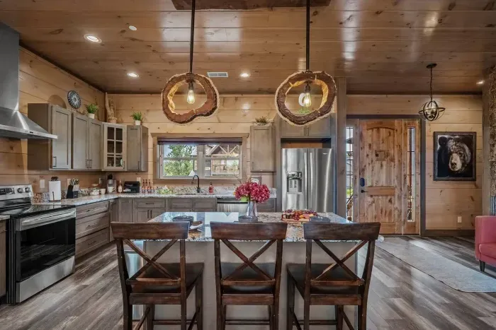 Fully stocked kitchen that is right inside the front door entrance of this luxury cabin.