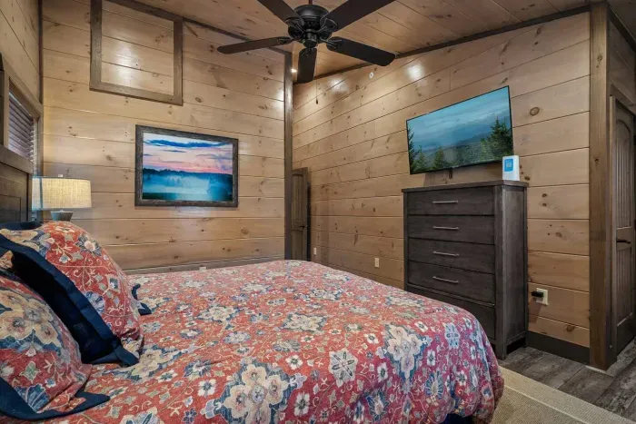 The third bedroom upstairs is styled with a beautiful red comforter + cozy vibes.