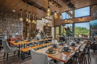 Luxury dining table area that seats 20 guests! Looking into the living room + mountain views.