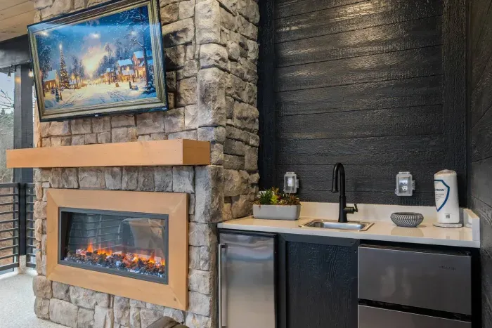 Rooftop wet bar with mini fridge and cozy fire feature