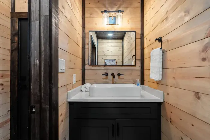 Half bath just inside the door from the rooftop