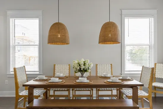 Dinner for eight under woven pendants. Pull everyone off the beach, pass the plates around, and let the evening run long.