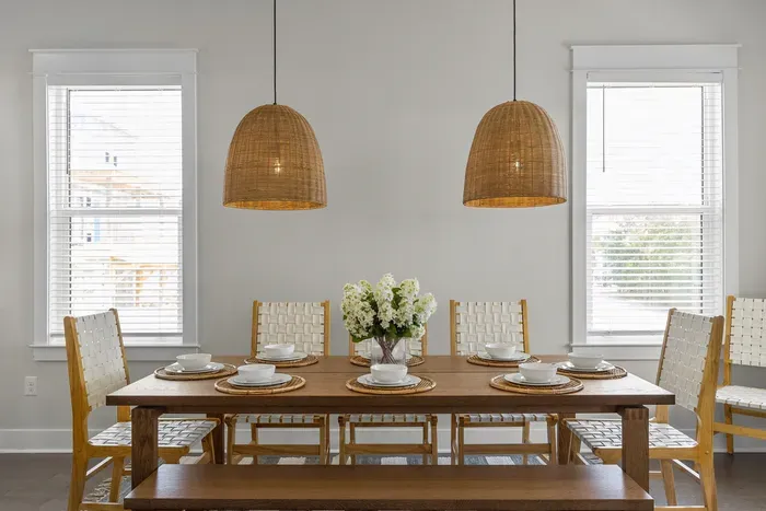Dinner for eight under woven pendants. Pull everyone off the beach, pass the plates around, and let the evening run long.