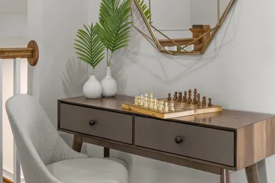 A chess set waits on the landing console for the slow part of the afternoon.