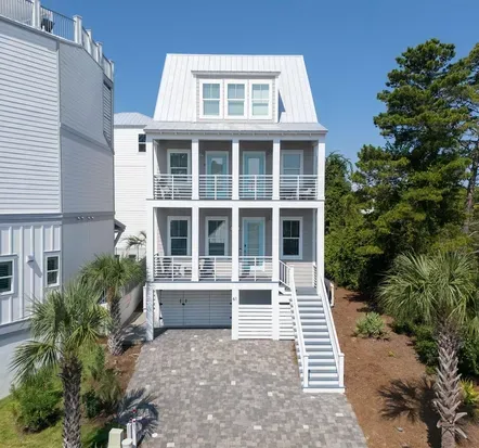 Three stories of coastal home on a quiet Dune Allen street. The parking pad is sloped but fits up to four cars if you park with a little strategy.