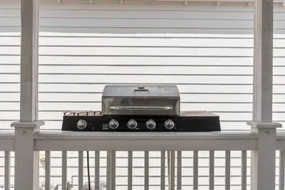 The Char-Broil propane grill sits on the covered back deck. Fire it up for the day's catch and eat outside.