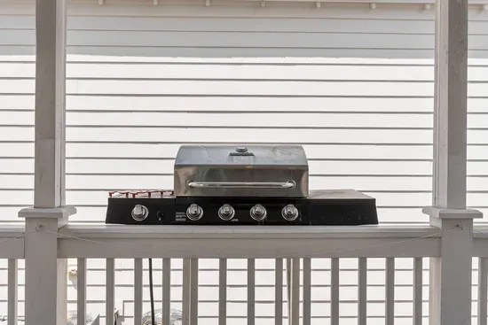 The Char-Broil propane grill sits on the covered back deck. Fire it up for the day's catch and eat outside.