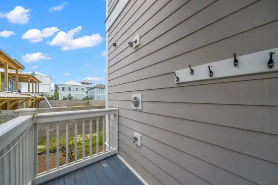 An outdoor shower on the back deck, for rinsing off the sand before it ever makes it inside.