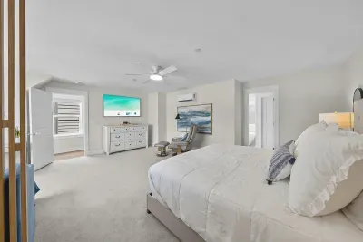 The third-floor primary is the quiet corner of the house, with a king bed, a smart TV, and a door you can close on everyone else.