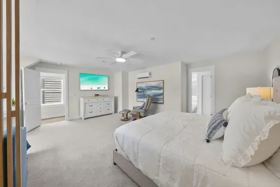 The third-floor primary is the quiet corner of the house, with a king bed, a smart TV, and a door you can close on everyone else.