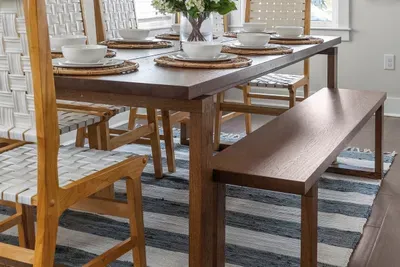 Bench seating on one side means you can always squeeze in one more without hunting for a chair.
