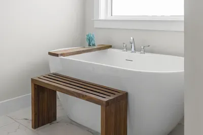 The freestanding tub, with a teak bench alongside it. Run a bath after a long day in the sun.