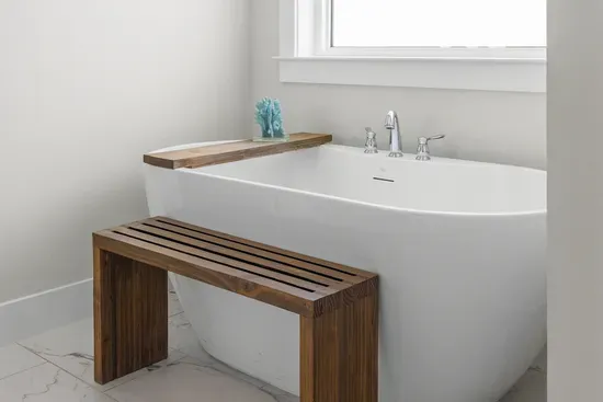 The freestanding tub, with a teak bench alongside it. Run a bath after a long day in the sun.