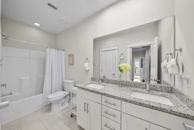 The shared second-floor bath has a dual-sink vanity and a shower and tub combo, which matters on the mornings everyone is getting ready at once.