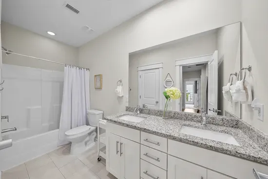 The shared second-floor bath has a dual-sink vanity and a shower and tub combo, which matters on the mornings everyone is getting ready at once.