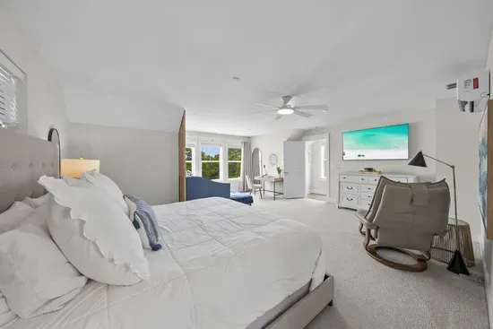 Nearly twenty by twenty-three feet of primary suite, with room for a bed, a sitting area, and a workspace all at once.