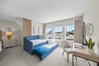Morning light, a daybed with a pullout trundle, and a desk by the window if you have to answer a few emails before the beach.