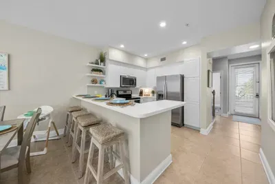 Counter stools line the kitchen counter, the favorite spot for morning coffee and snacks while someone cooks. The kitchen opens to the living space so nobody misses a thing.