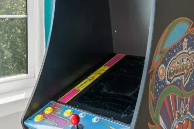 A closer look at the Ms. Pac-Man/Galaga cabinet, with bold art and a bright button panel. A throwback the kids and parents will both enjoy.