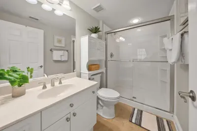 A walk-in glass shower and a long vanity make this bathroom easy to share. A hair dryer is on hand, so you can pack a little lighter.