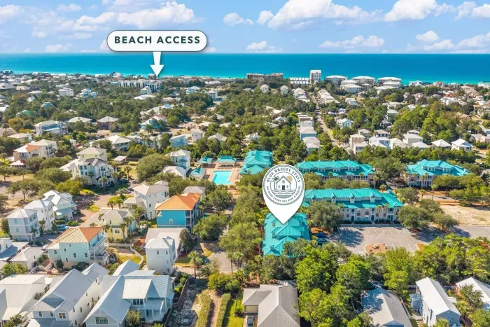 The location is the headline. The Blue Mountain Beach public access is about a half mile away, with dinner, coffee and ice cream even closer. Park once and walk to it all.