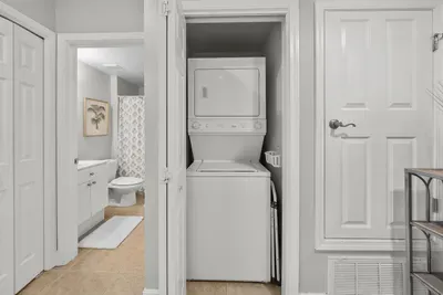 A stackable washer and dryer sit right inside the front door, with detergent provided. Pack lighter and refresh beach towels mid-stay.