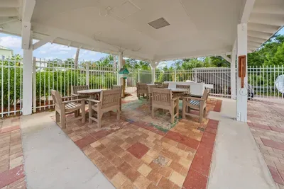 A covered pavilion with picnic tables near the pool, a shady spot for lunch, cards or a break from the sun.