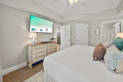 A wall-mounted TV above the dresser makes it easy to wind down with a movie. Room to unpack, plus hangers in the closet.