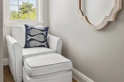 A quiet reading nook with a cushy chair and ottoman. Grab a book and claim a corner while the rest of the group is out on the beach.