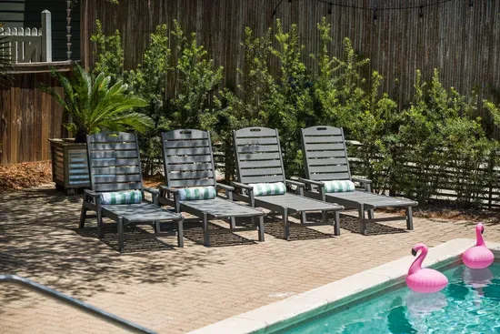 Adirondack chairs tucked into the yard offer a quiet corner to relax with a book or an evening drink.