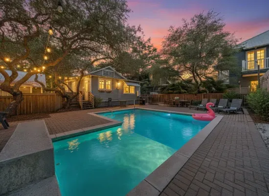 End your beach days right here — the private heated pool glows under string lights as the sky turns pink. With a tanning ledge, waterfall, and a fully fenced yard, this backyard is the heart of Lollygag.