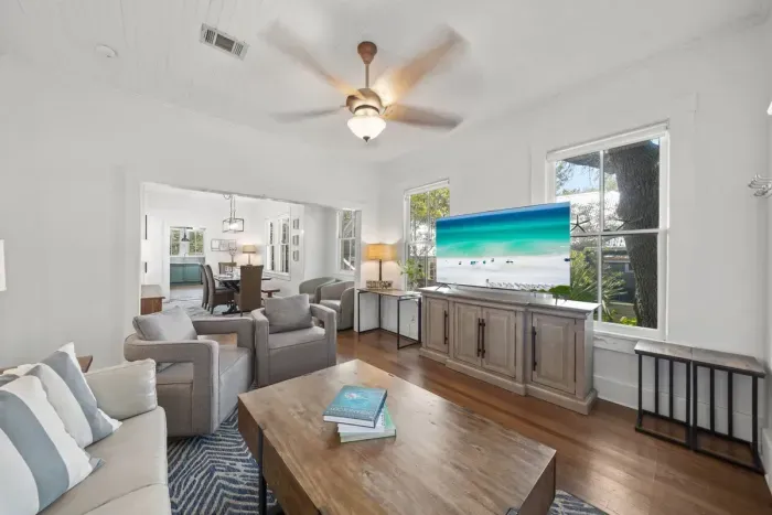 An open, light-filled living and kitchen area keeps everyone together, with comfortable seating for seven flowing into the dining space and a fully stocked kitchen.