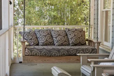 Sink into the porch swing — a breezy, shaded spot on the screened-in porch to relax with a book or an evening drink.