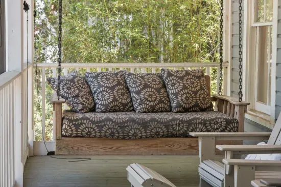 Sink into the porch swing — a breezy, shaded spot on the screened-in porch to relax with a book or an evening drink.