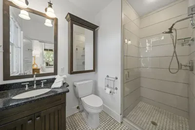 The master's private ensuite features a sleek vanity and a walk-in tile shower for an easy rinse-off after the beach.