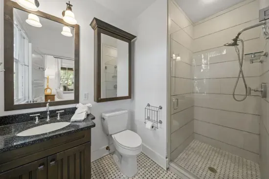 The master's private ensuite features a sleek vanity and a walk-in tile shower for an easy rinse-off after the beach.